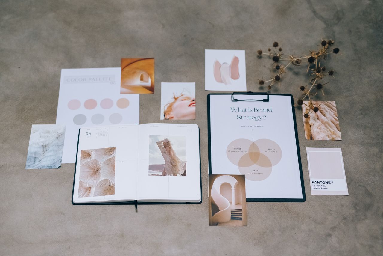 services-03 A flat lay of branding elements with color palettes and strategic planning documents on a concrete surface.